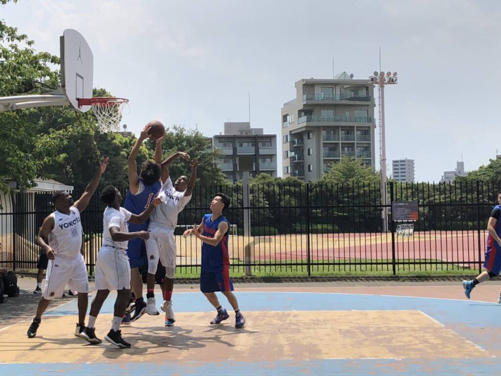 オールデイ大会でゴール下で囲まれながらシュートする場面